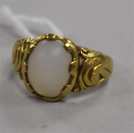 A yellow metal and moonstone? cabochon ring, 9g